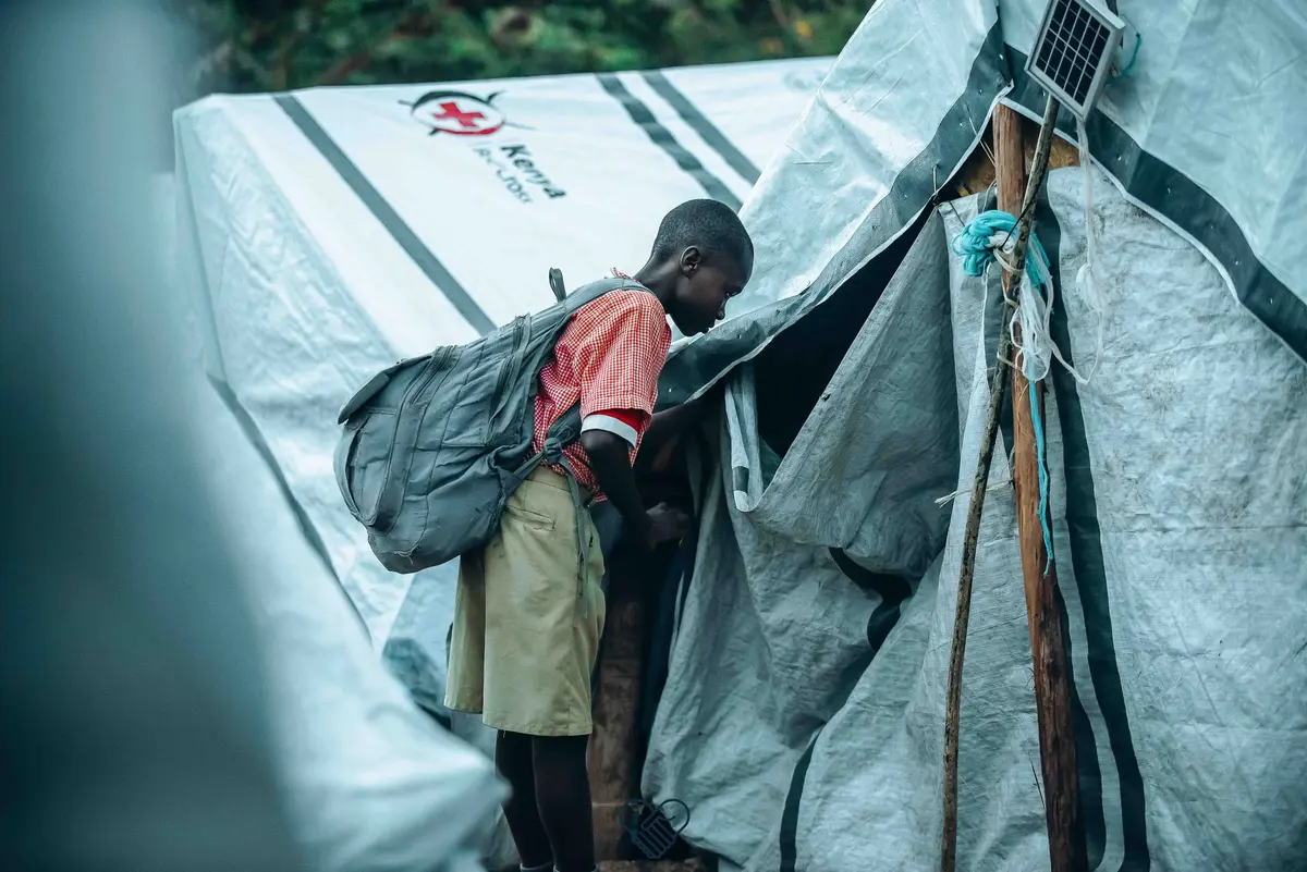 A young boy walks into an IDP tent in Homa Bay County after devastating floods displaced hundred