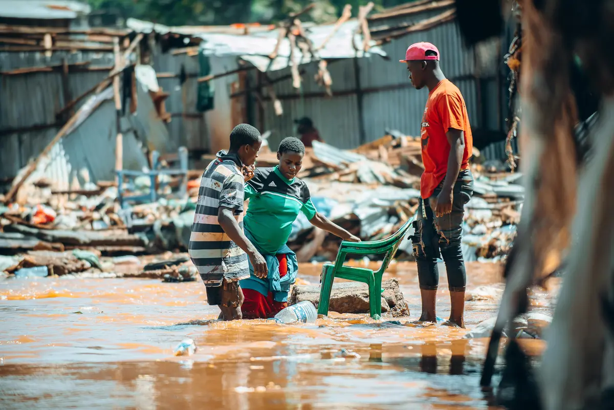 A pregnant mother of two being rescued from floodwaters in Mathare.
