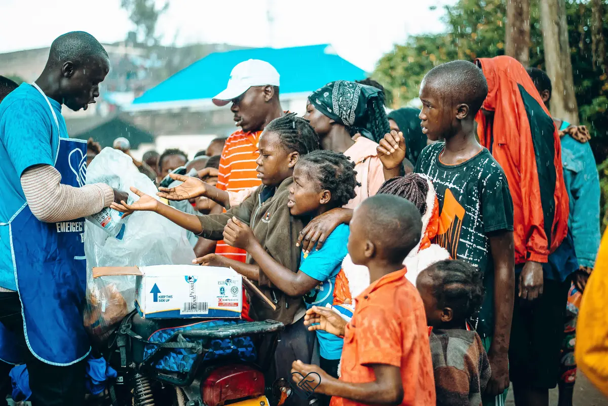 Convoy of Hope volunteers giving milk and bread to flood-displaced children in Mathare Slum.