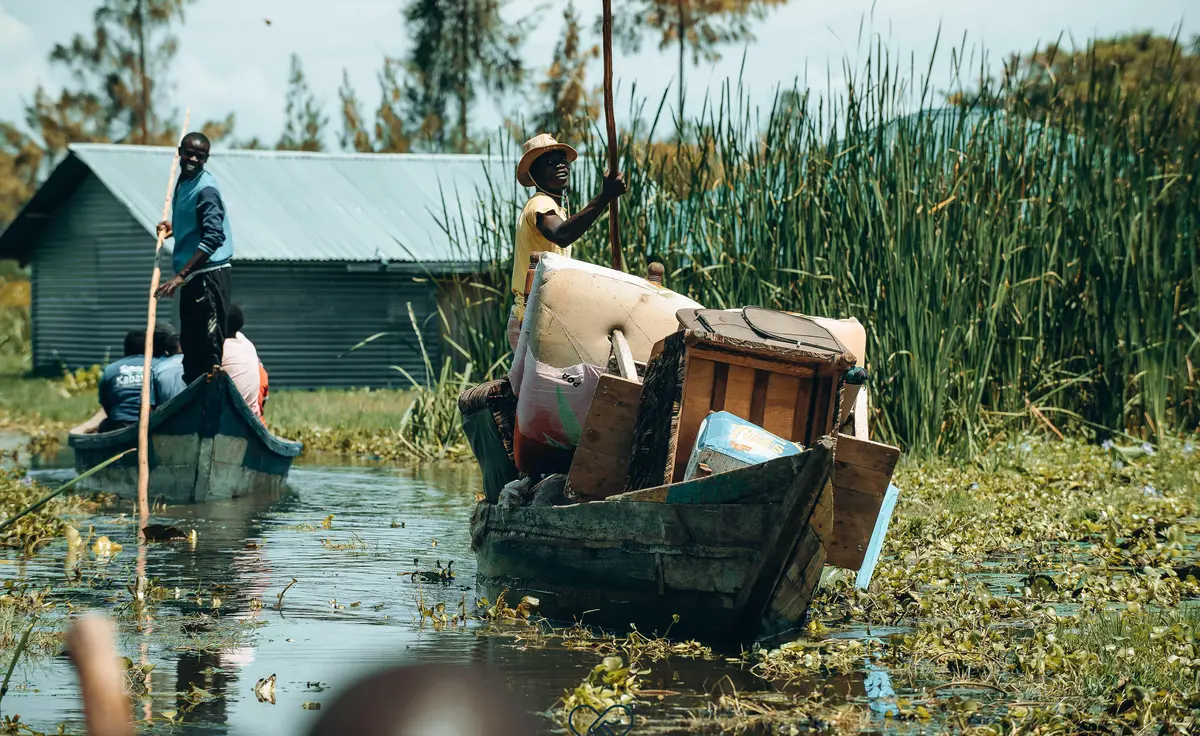 Residents of Ahero, Kisumu, using boats to rescue belongings after floods submerged their homes.